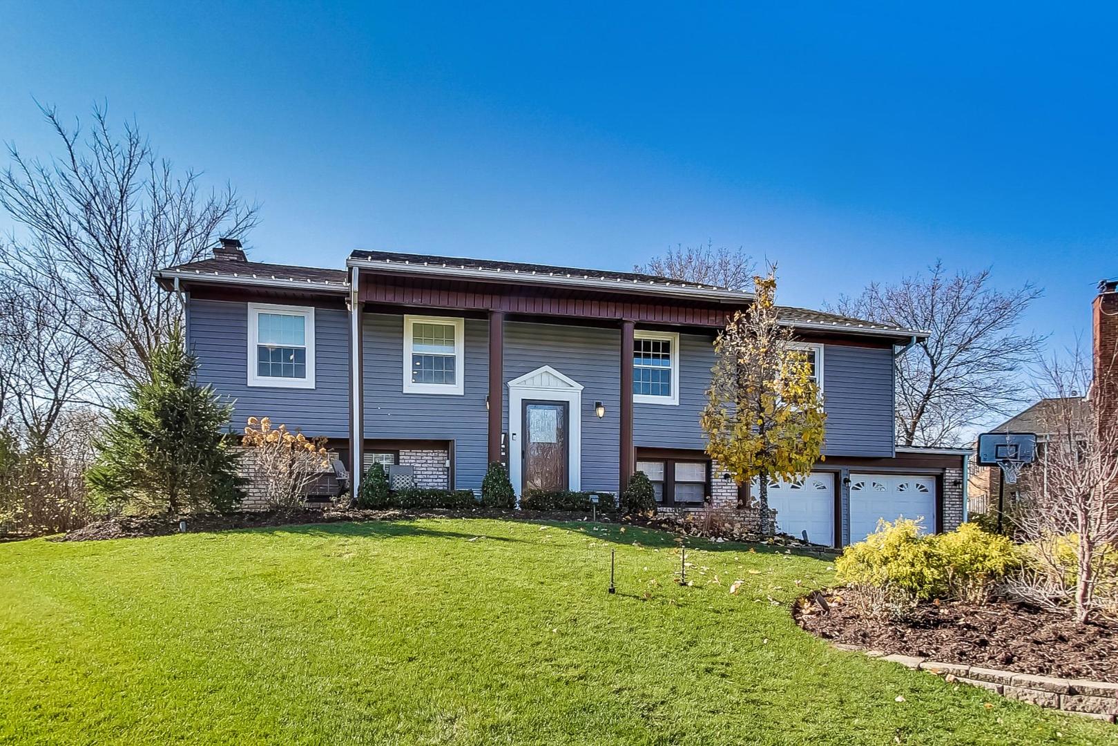 34 Timber Hill Road Buffalo Grove, IL 60089 - Photo 1 of 37 a front view of a house with a yard