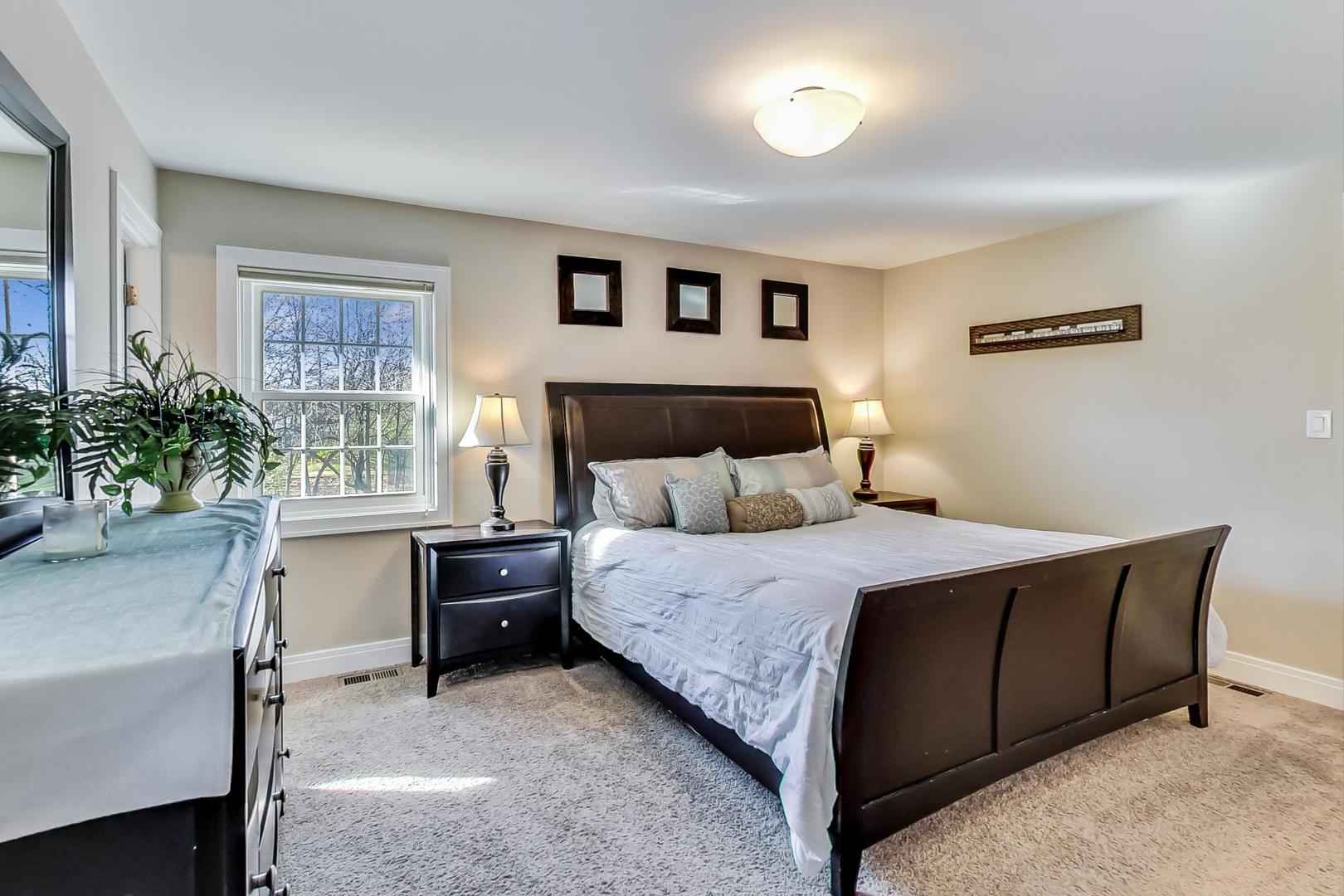 34 Timber Hill Road Buffalo Grove, IL 60089 - Photo 12 of 37 a bedroom with a bed and a potted plant