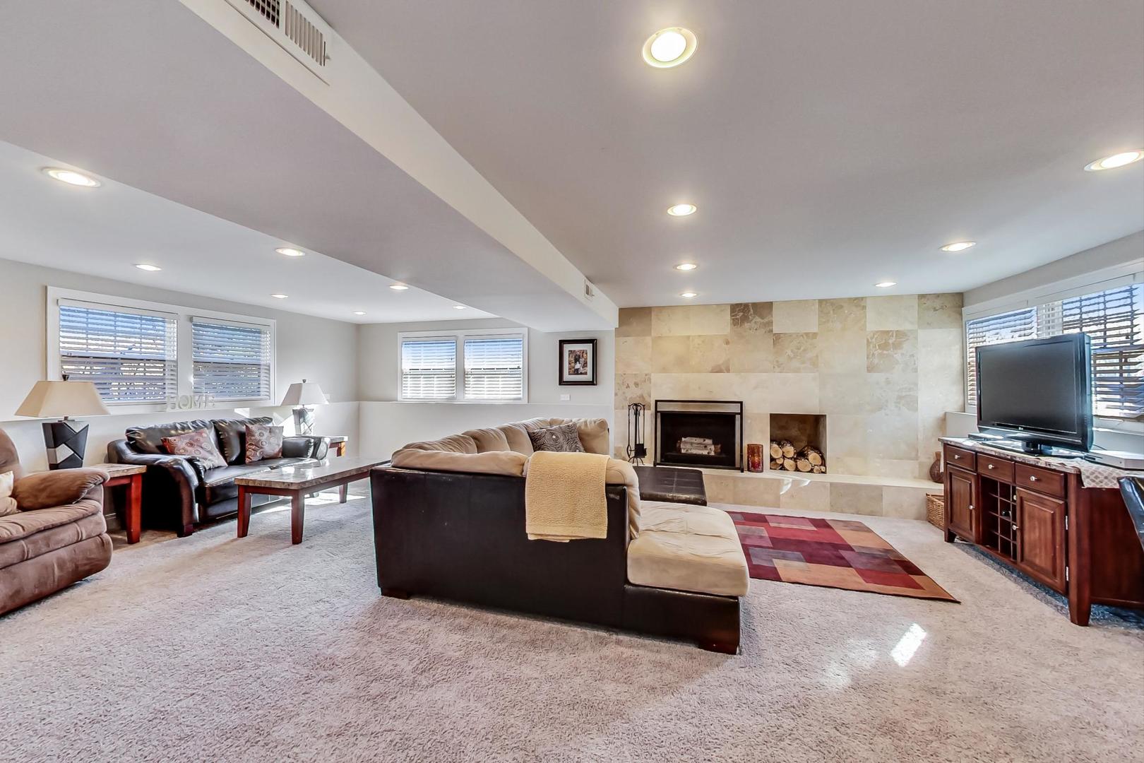 34 Timber Hill Road Buffalo Grove, IL 60089 - Photo 17 of 37 a living room with fireplace furniture and a flat screen tv