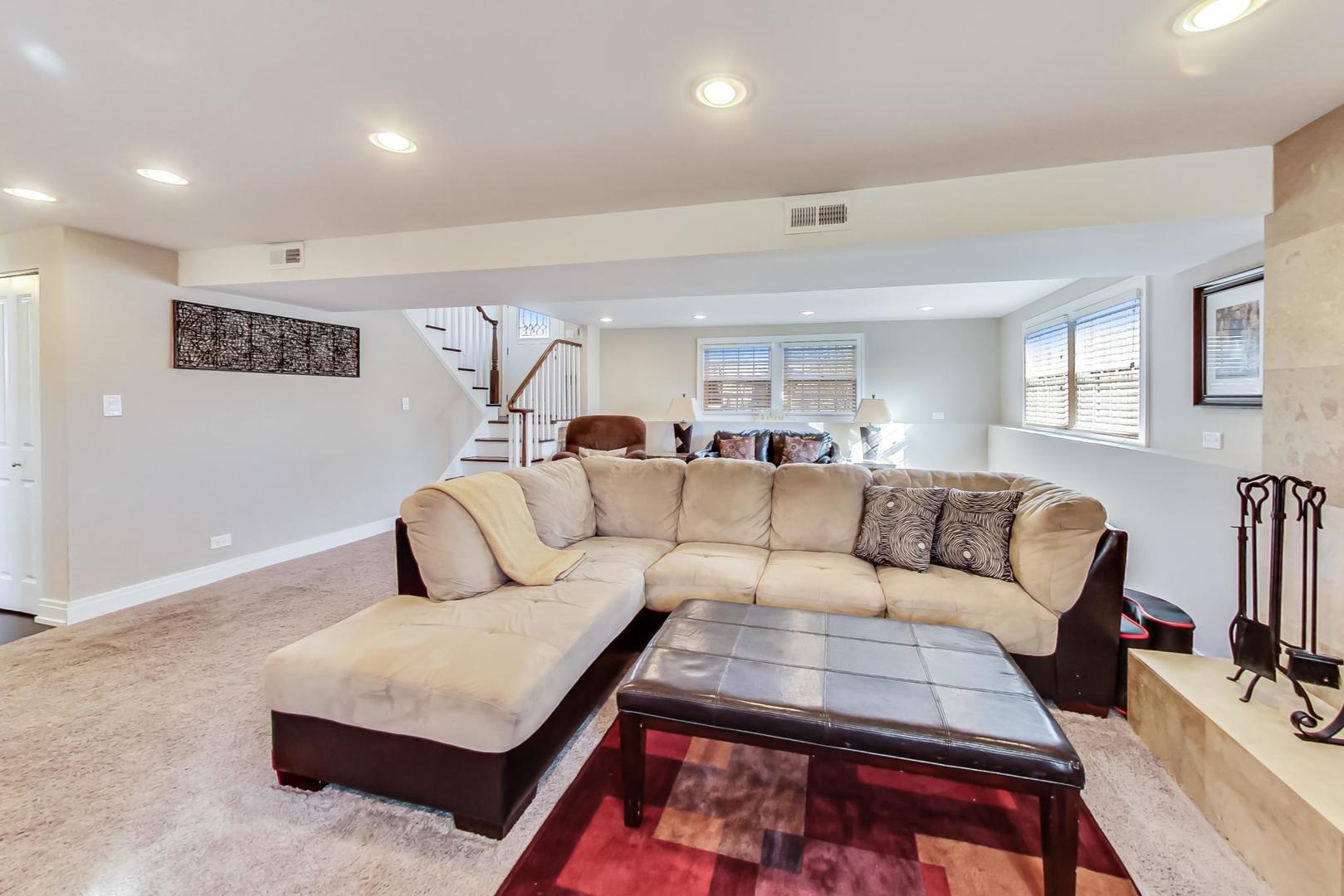 34 Timber Hill Road Buffalo Grove, IL 60089 - Photo 18 of 37 a living room with furniture a rug and a painting on the wall