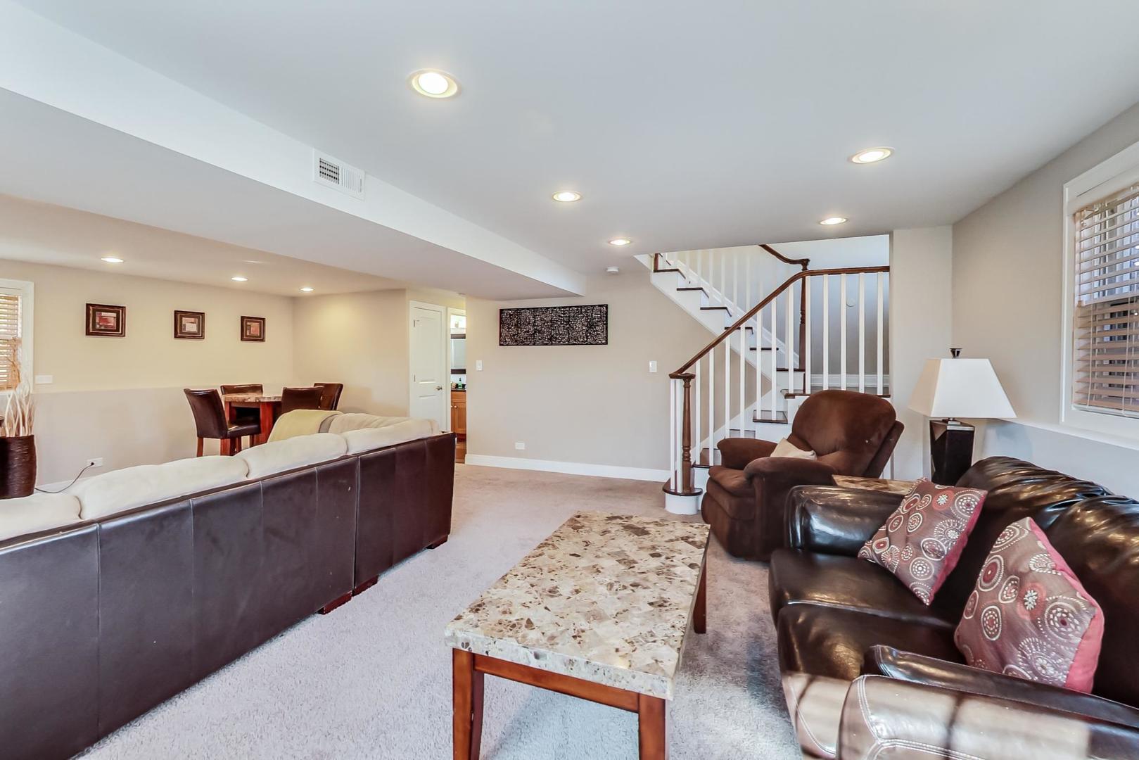 34 Timber Hill Road Buffalo Grove, IL 60089 - Photo 19 of 37 a living room with furniture a wooden floor and a sink