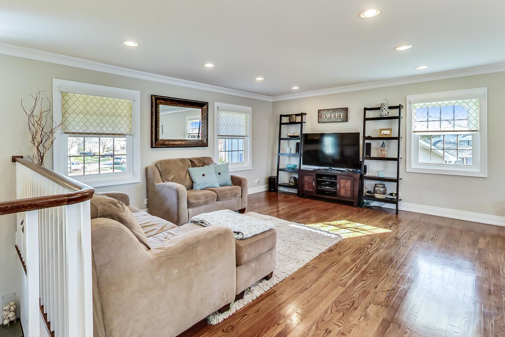 34 Timber Hill Road Buffalo Grove, IL 60089 - Photo 3 of 37 a living room with furniture and a flat screen tv