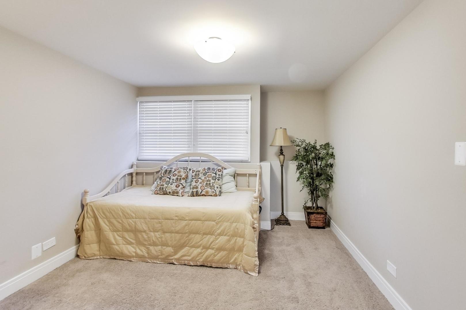 34 Timber Hill Road Buffalo Grove, IL 60089 - Photo 21 of 37 a bedroom with a bed and a potted plant