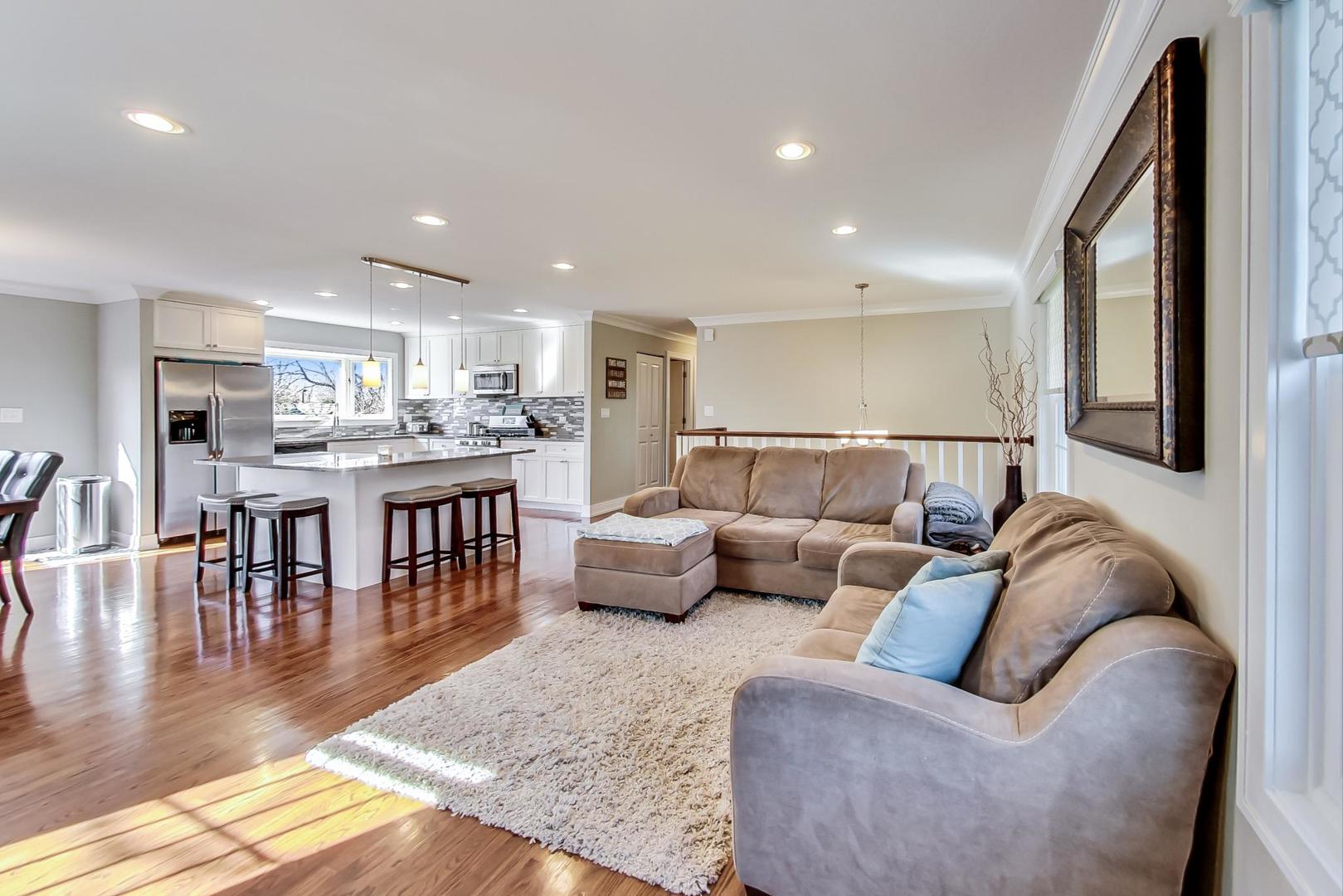 34 Timber Hill Road Buffalo Grove, IL 60089 - Photo 5 of 37 a living room with furniture and a dining table with wooden floor