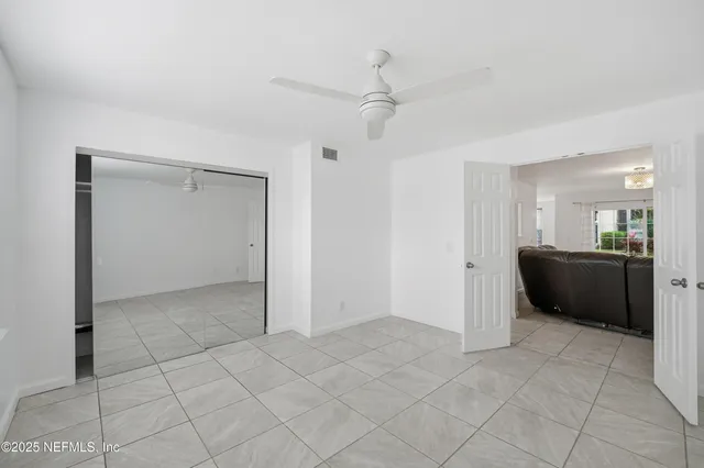 a view of a kitchen with a sink and a refrigerator
