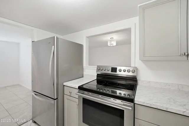a kitchen with a stove and a refrigerator