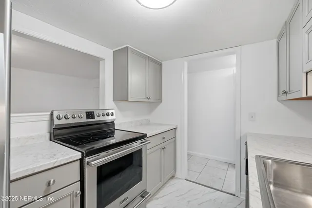 a kitchen with a stove and a sink