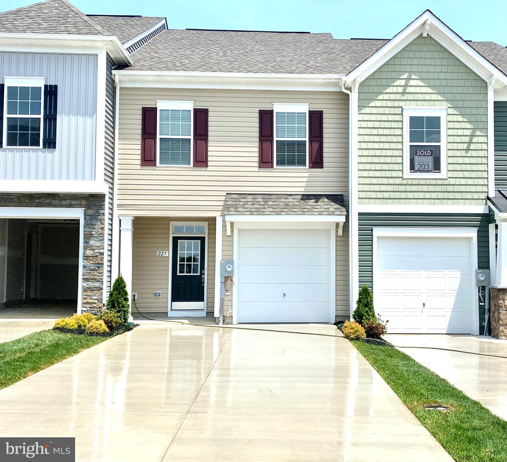 a view of a house with a yard and garage