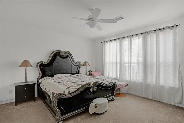 a bed sitting in a bedroom next to a window