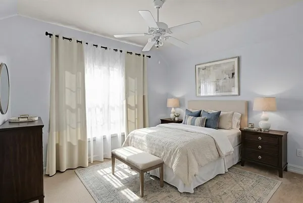 a bedroom with a bed a lamp and a window