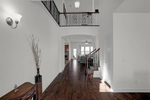 a view of entryway and hall with wooden floor
