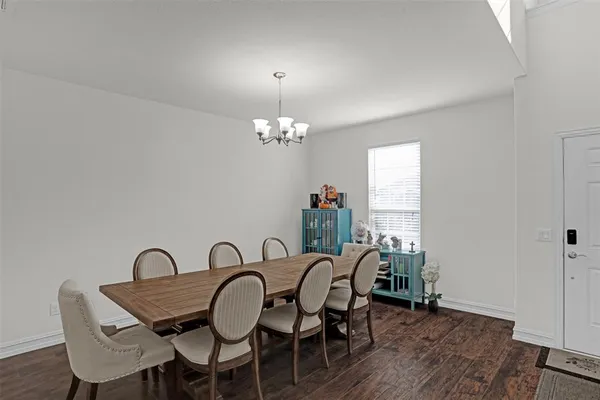 a view of a dining room with furniture and chandelier