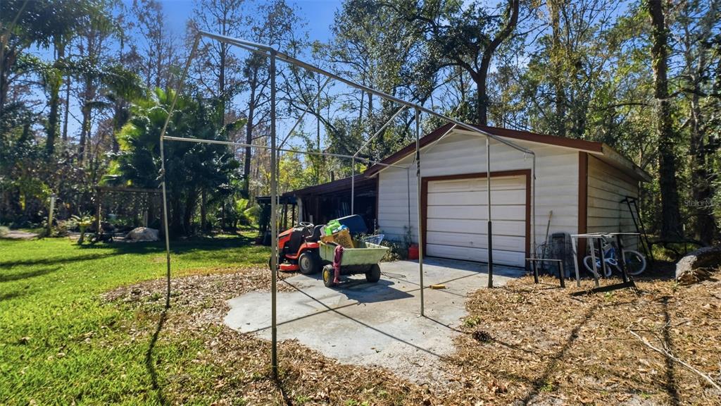 10565 Bessemer Street New Port Richey, FL 34654 - Photo 36 of 72 a view of a house with a yard and sitting area