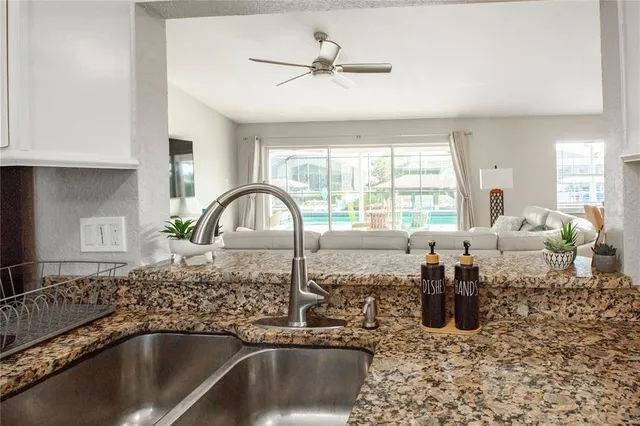 a kitchen with a sink and a large window