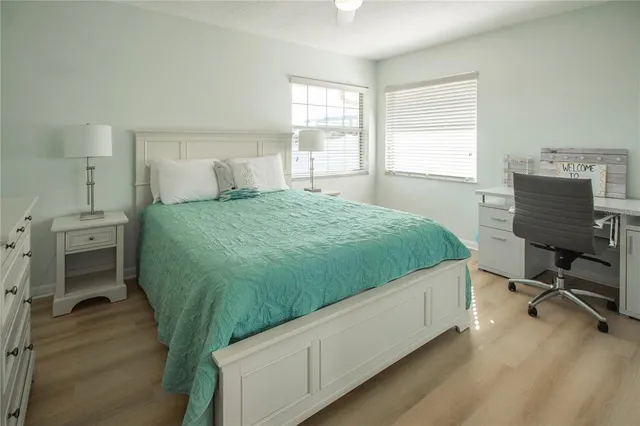 a bedroom with a bed a table and chair