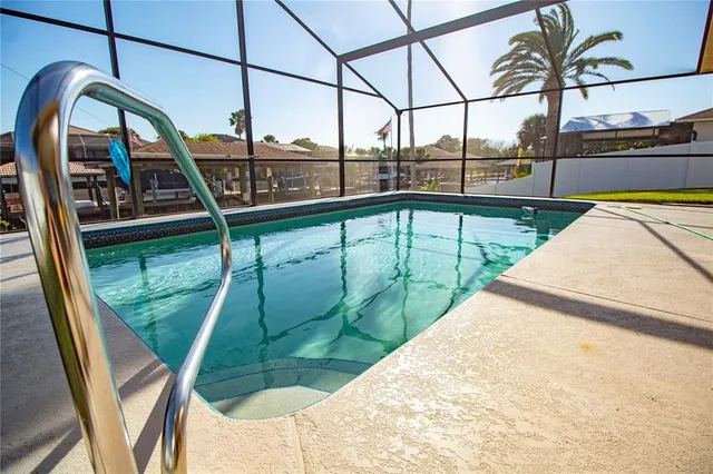 a view of swimming pool with a couches and chairs