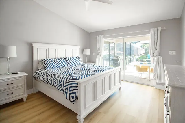 a bedroom with a bed and a large window