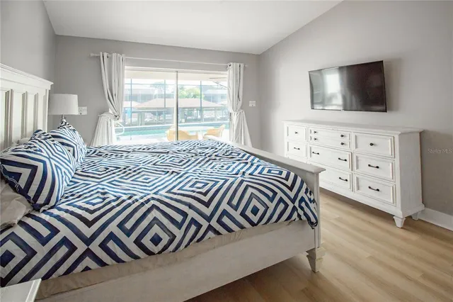 a bedroom with a bed and a flat screen tv