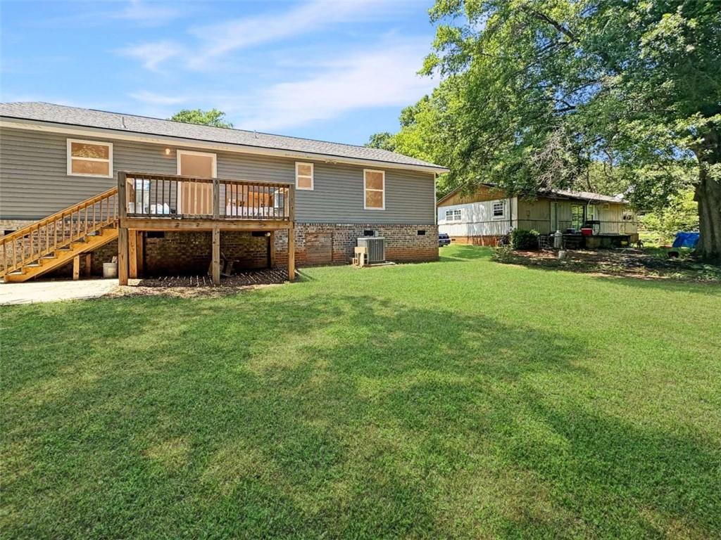 24 George Street Forsyth, GA 31029 - Photo 4 of 17 a view of a house with a big yard and large trees