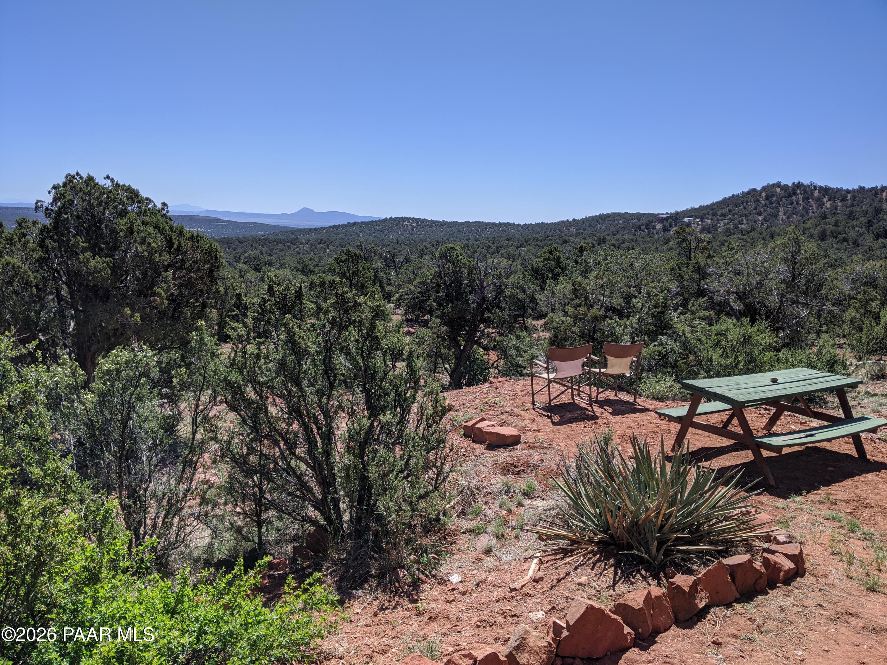 33749 West Whiskey River Road, Unit 21 Seligman, AZ 86337 - Photo 32 of 41 a view of a backyard with couches under an umbrella
