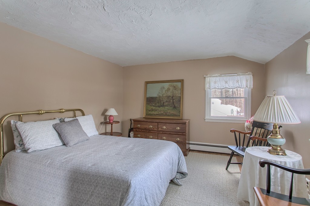 32 Shawnee Road Pepperell, MA 01463 - Photo 15 of 27 a bedroom with a bed and a table in it