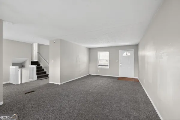 a view of empty room with white walls