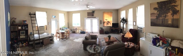 10235 Shark Road West Jacksonville, FL 32226 - Photo 21 of 40 a living room with furniture and large windows