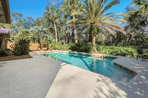 a view of a swimming pool with a yard