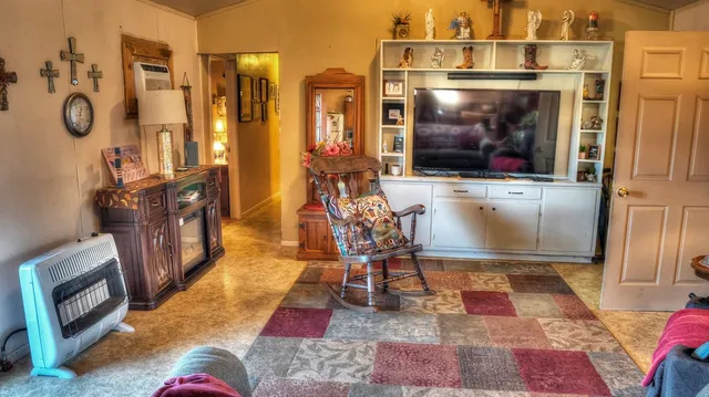 a living room with patio furniture and a fireplace