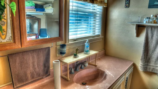 a bathroom with a sink a mirror and shower