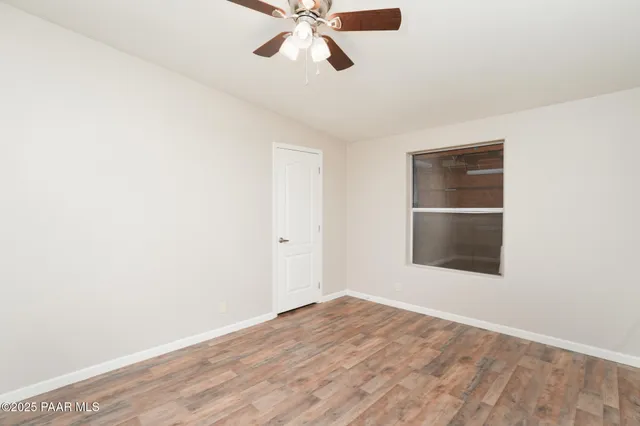 a view of a room with a fan and a ceiling fan