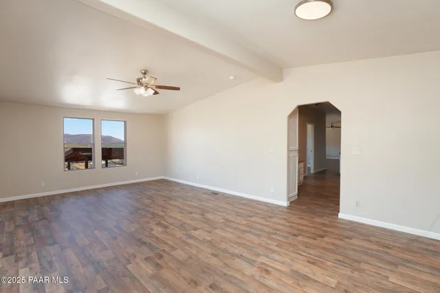 a kitchen with stainless steel appliances granite countertop a sink cabinets and wooden floor
