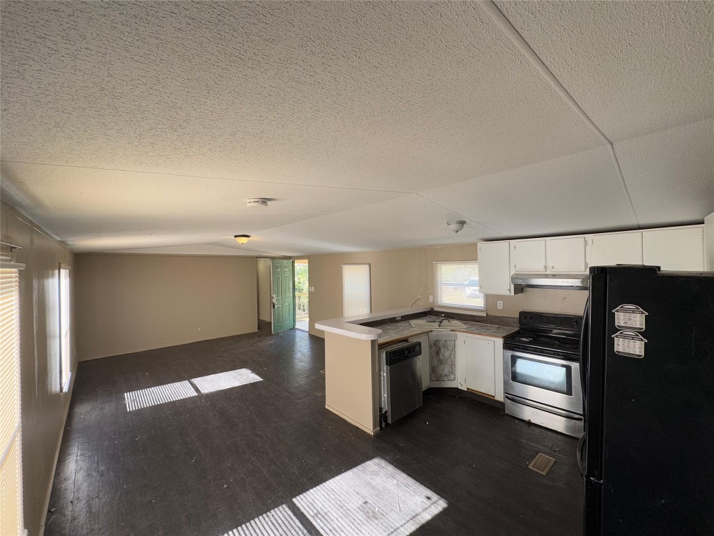 8315 Burleson Manor Road, Unit B Manor, TX 78653 - Photo 15 of 15 a kitchen with a stove top oven and refrigerator