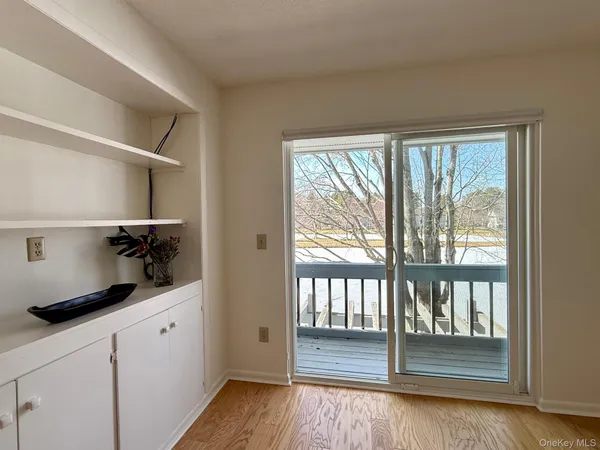 a kitchen with a large window and cabinets