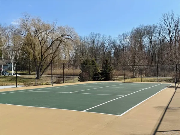 a view of an outdoor space and tennis court