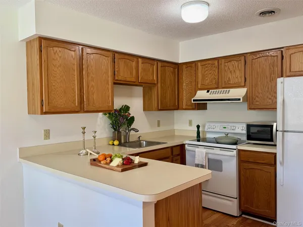 a kitchen with a sink cabinets and appliances
