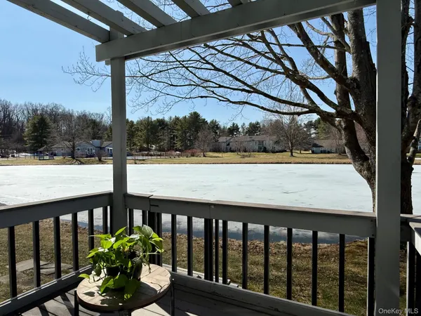 a porch with a bench next to a yard