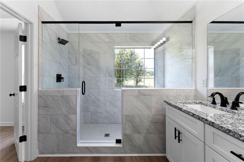 20 Mallet Pointe Street Northeast Cartersville, GA 30121 - Photo 23 of 37 a bathroom with a granite countertop shower sink and mirror