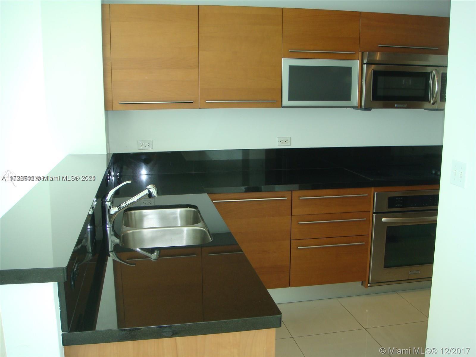 a kitchen with a sink and washing machine
