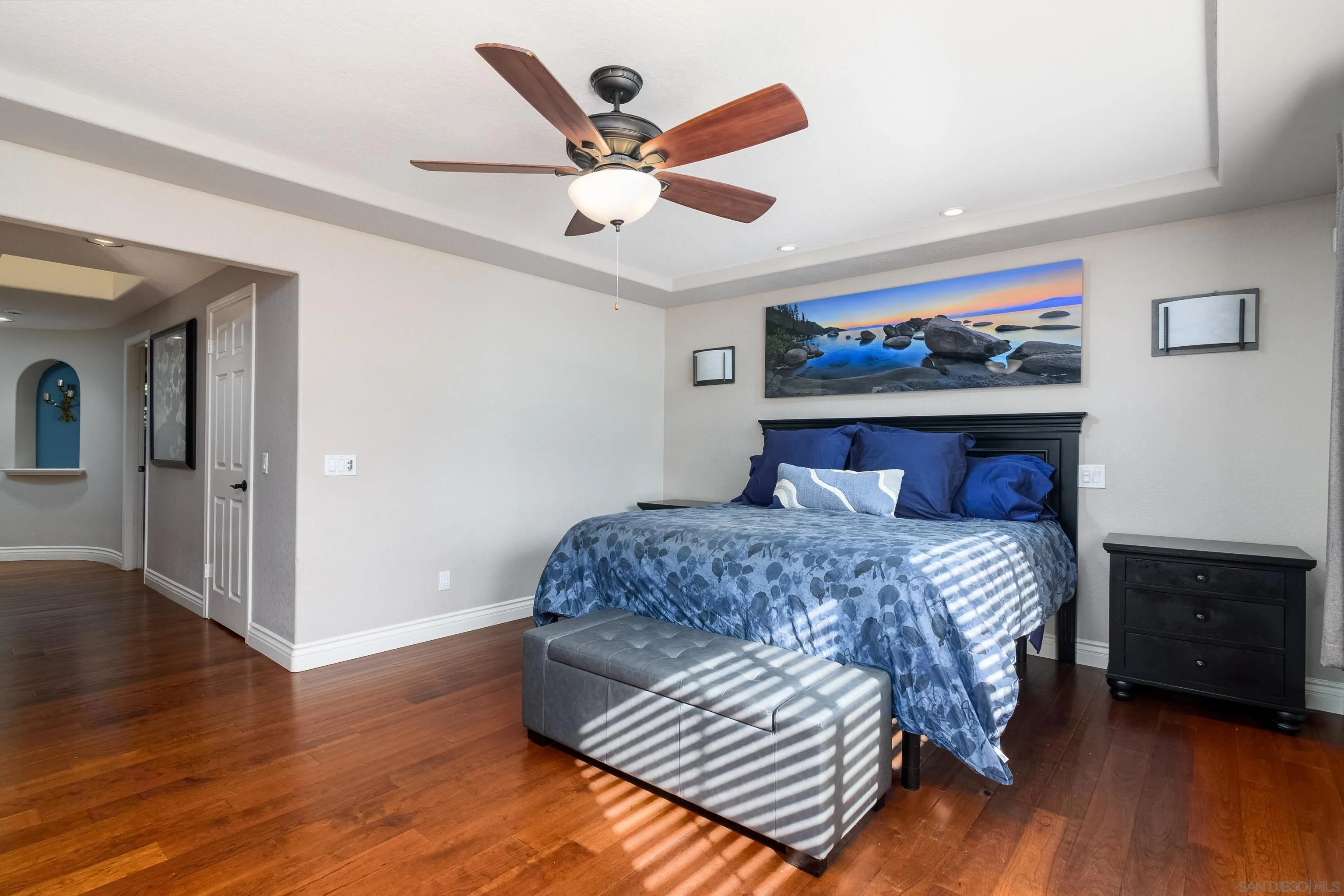 23949 Barona Mesa Road Ramona, CA 92065 - Photo 18 of 35 a bedroom with a large bed a chandelier and closet
