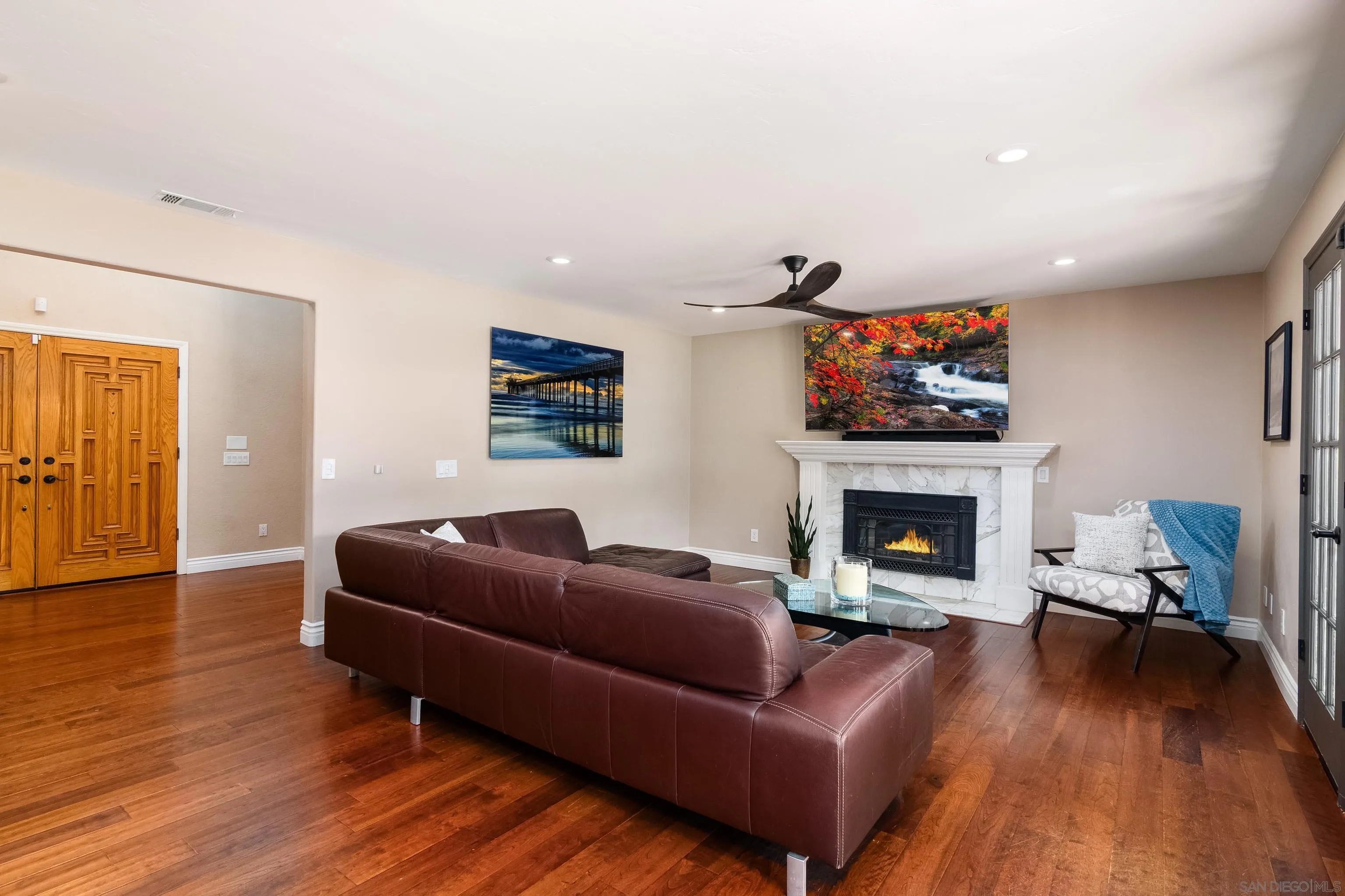 23949 Barona Mesa Road Ramona, CA 92065 - Photo 5 of 35 a living room with furniture a flat screen tv and a fireplace