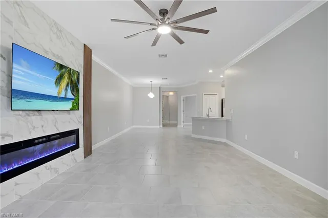 a view of a hallway with a ceiling fan and window