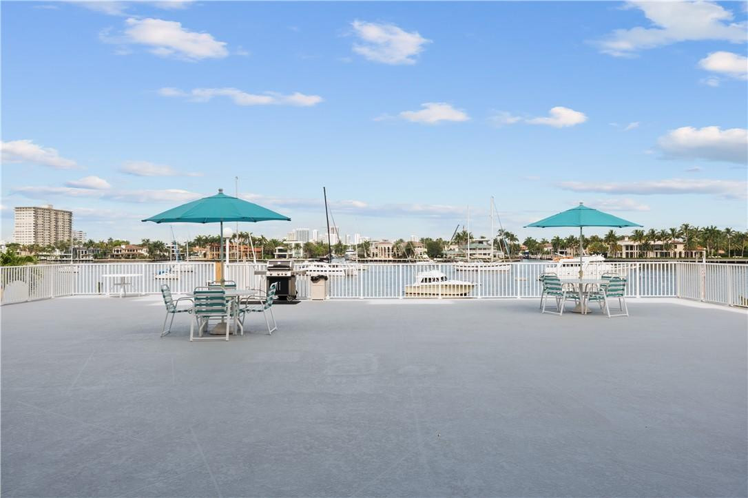 95 North Birch Road, Unit 405 Fort Lauderdale, FL 33304 - Photo 33 of 34 a room with lots of table and chairs