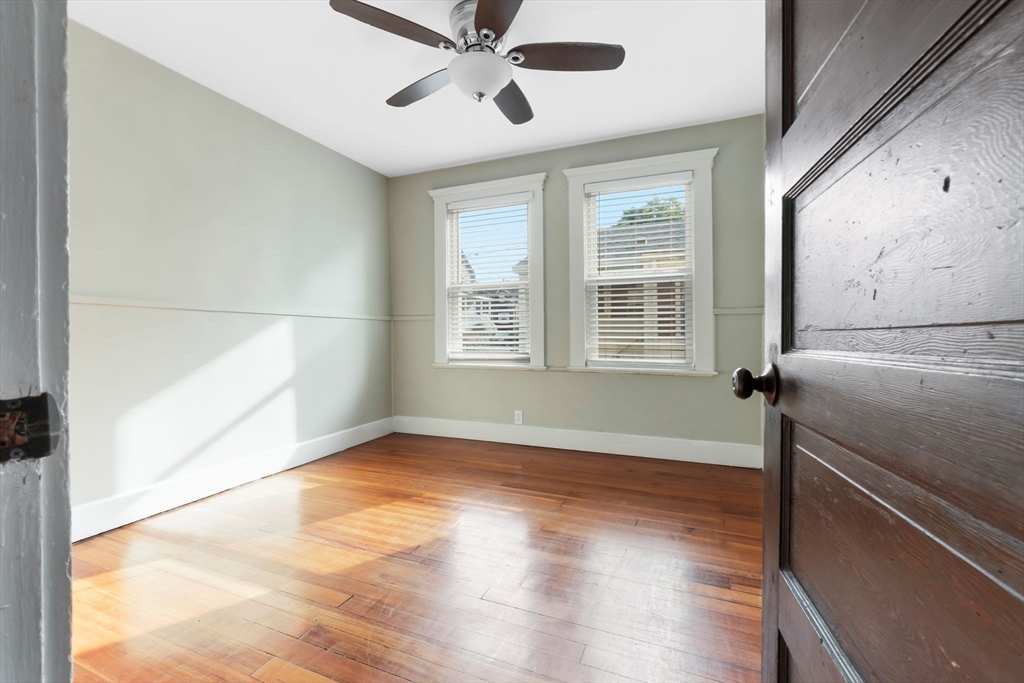 21 Goodell Street, Unit 1 Salem, MA 01970 - Photo 13 of 19 a view of an empty room with wooden floor and a window