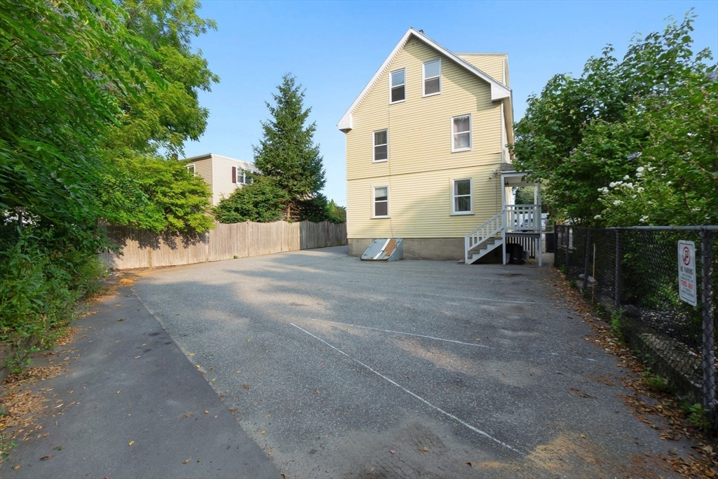 21 Goodell Street, Unit 1 Salem, MA 01970 - Photo 18 of 19 a view of white house with a yard and large trees