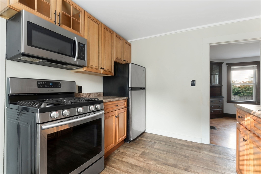 21 Goodell Street, Unit 1 Salem, MA 01970 - Photo 2 of 19 a kitchen with stainless steel appliances granite countertop a stove microwave and refrigerator