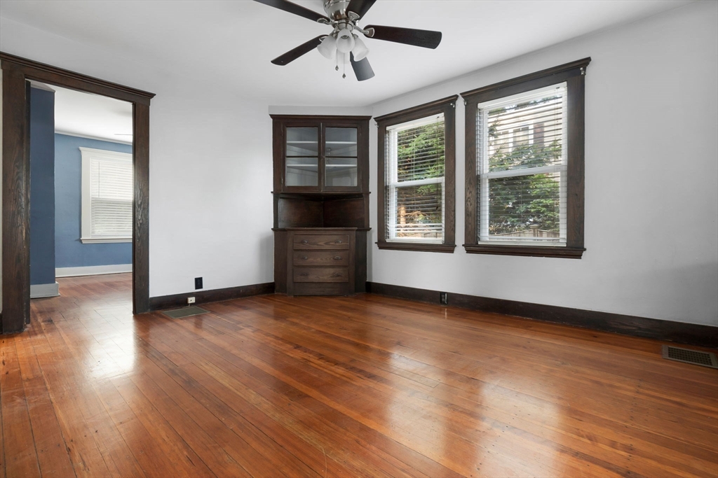 21 Goodell Street, Unit 1 Salem, MA 01970 - Photo 5 of 19 a view of an empty room with wooden floor and a window