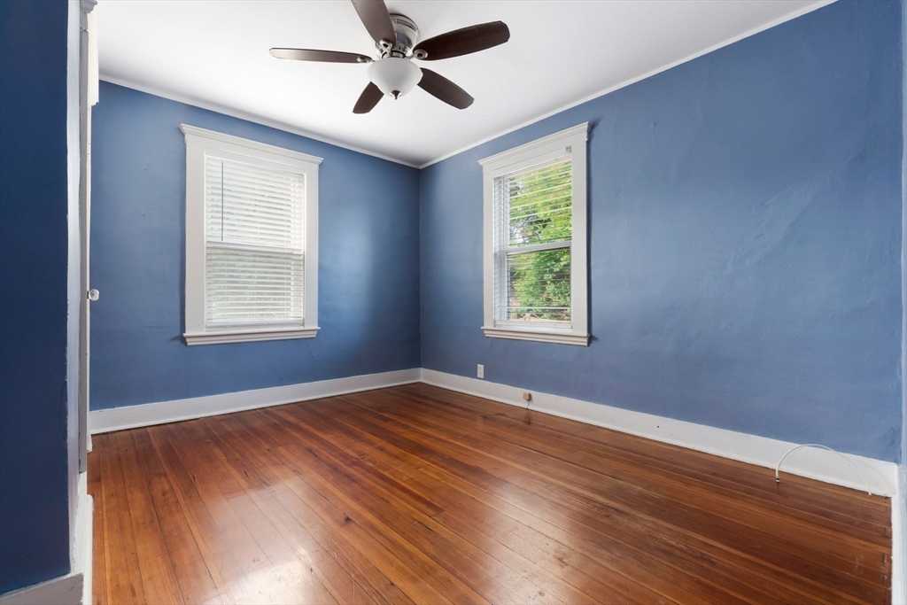 21 Goodell Street, Unit 1 Salem, MA 01970 - Photo 9 of 19 a view of an empty room with wooden floor and a window