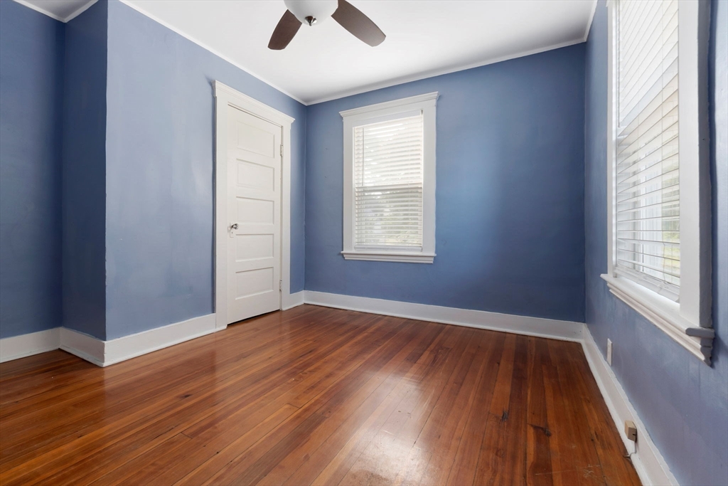 21 Goodell Street, Unit 1 Salem, MA 01970 - Photo 10 of 19 an empty room with wooden floor and windows