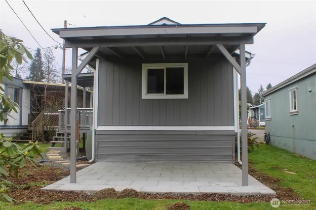 a view of backyard with barbeque grill and plants
